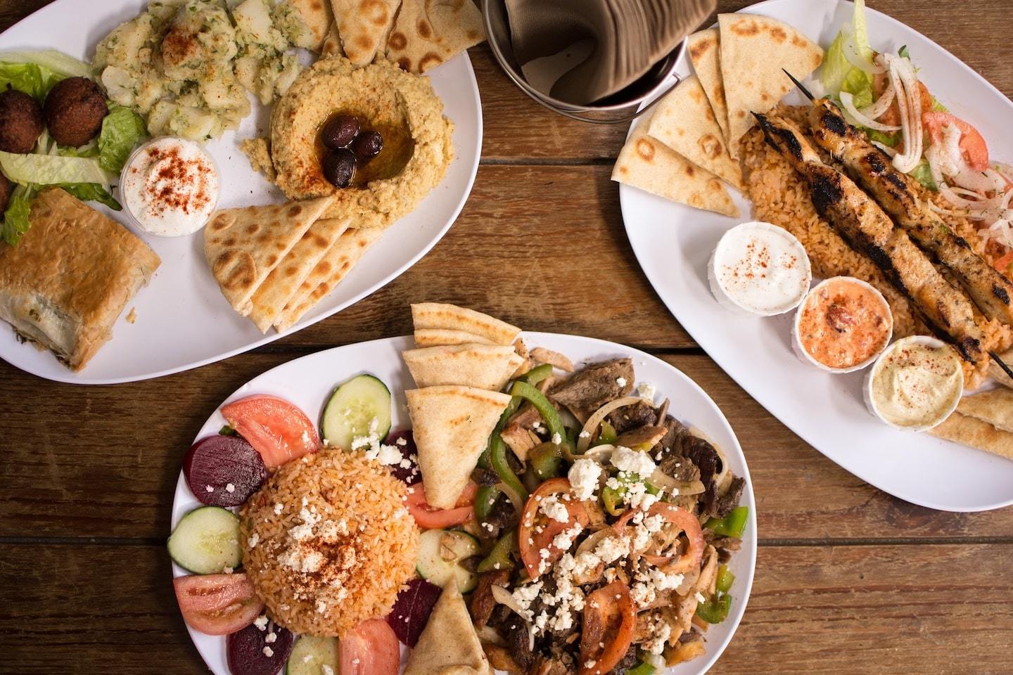 View of three plates full of traditional Greek food