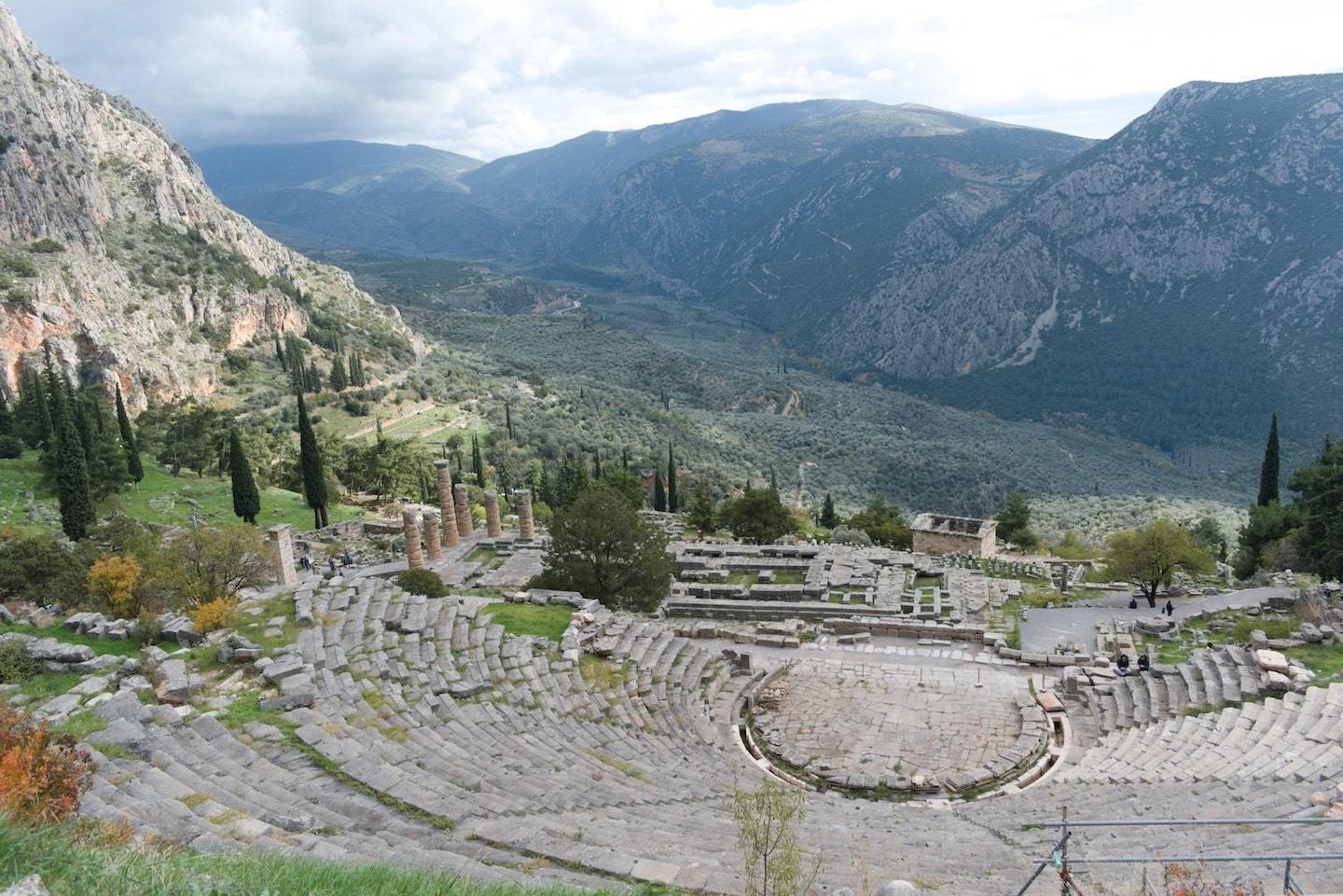 View of an Ancient Greek theater surrounded by mountains in Delphi, Greece.