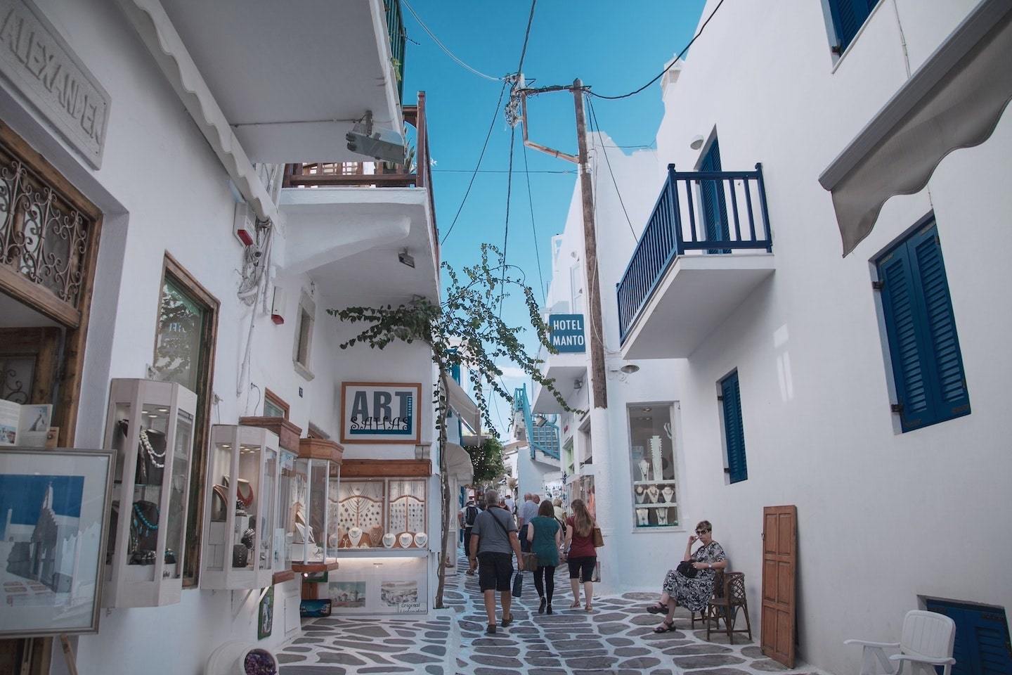 Greece islands: White buildings and shops in a small street in Mykonos, Greece