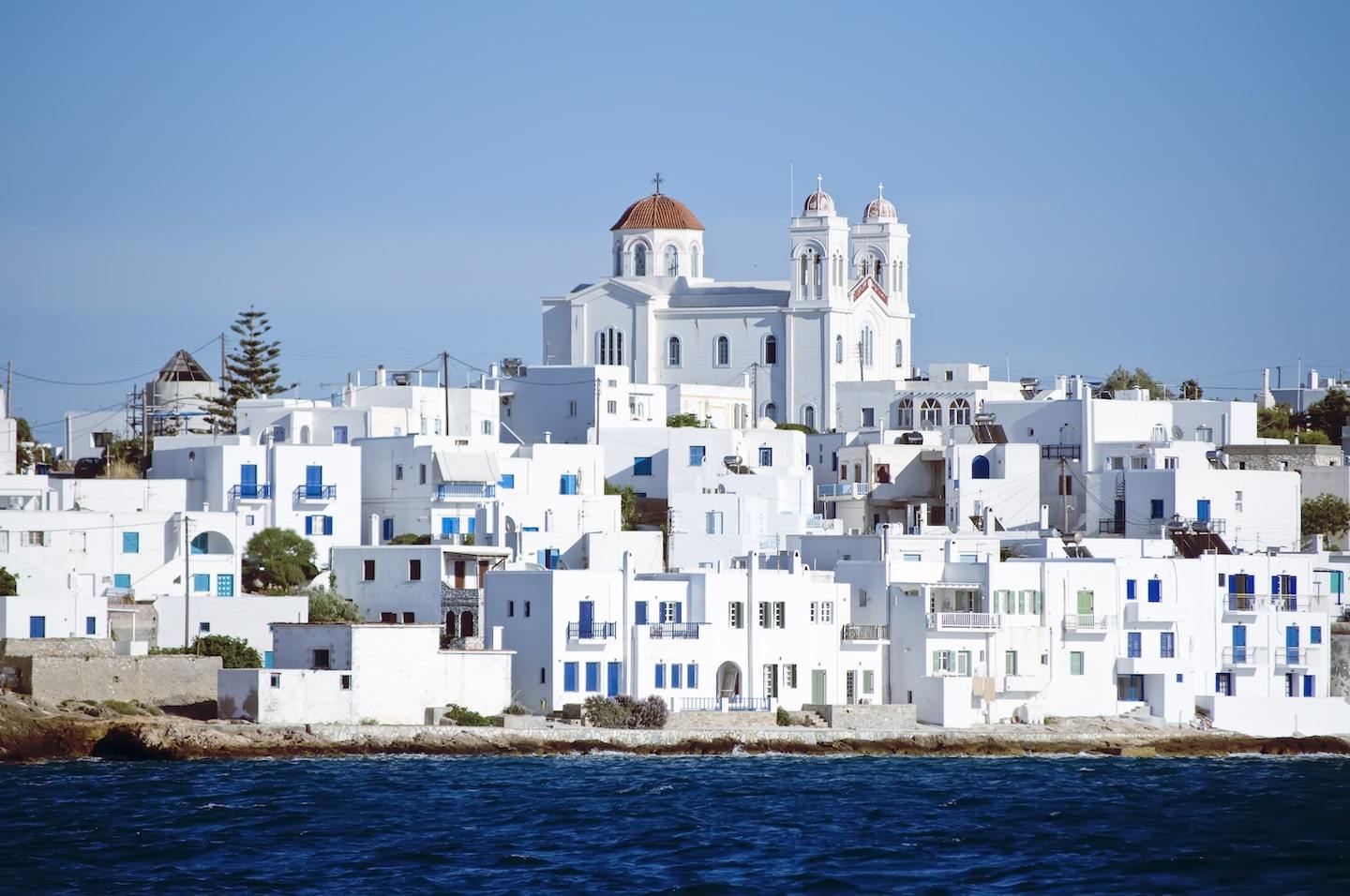 Cyclades Islands: white washed town with sea in front in Paros Greece