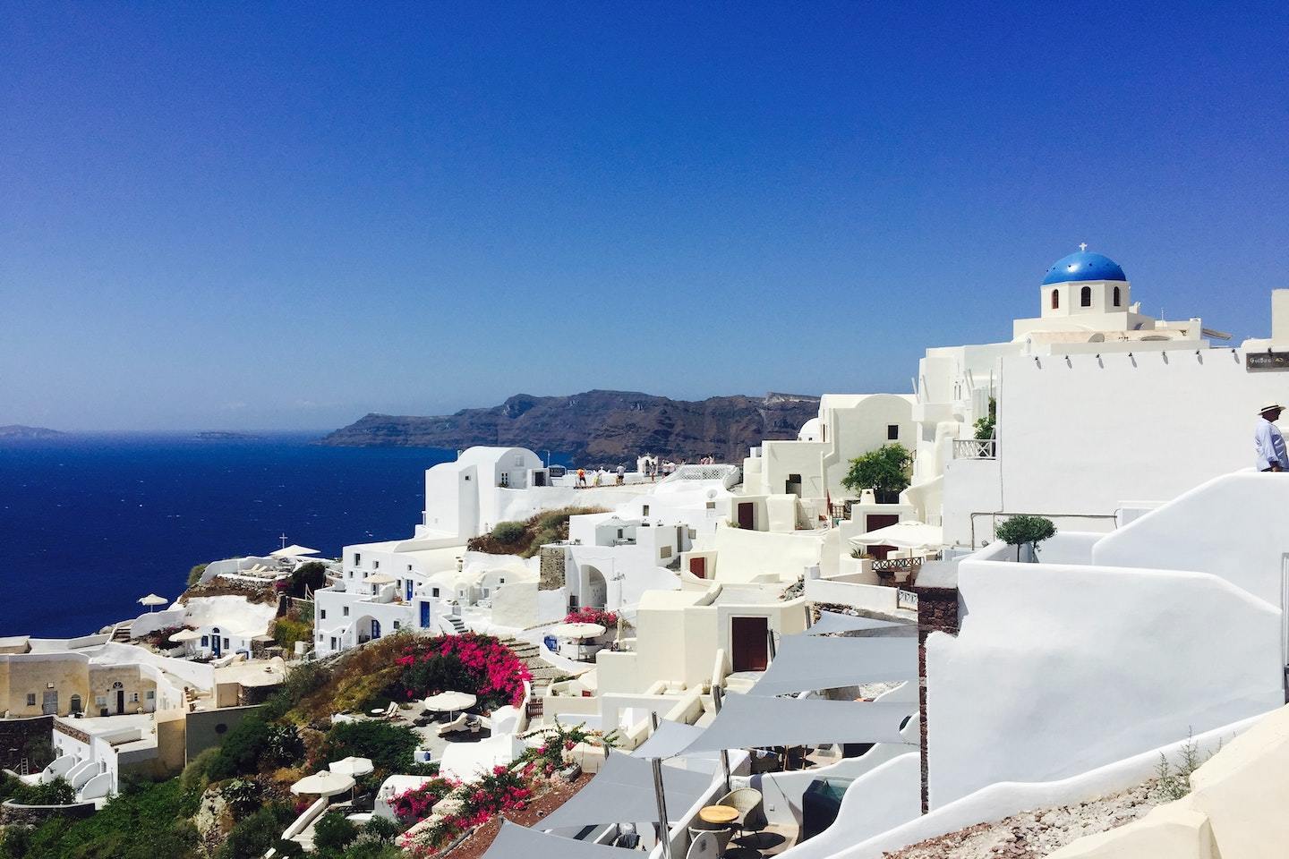 White buildings under a blue sky in Santorini, one of the best places to visit in Greece.