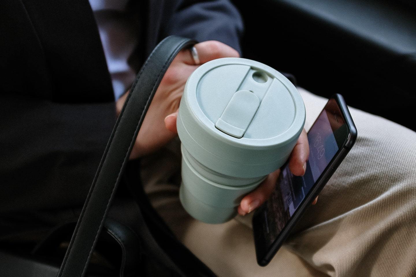 way to travel sustainably: bring a reusable coffee cup