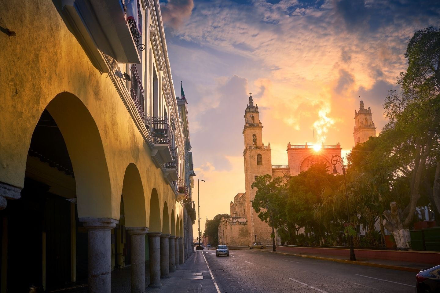 merida mexico with sun setting behind cathedral