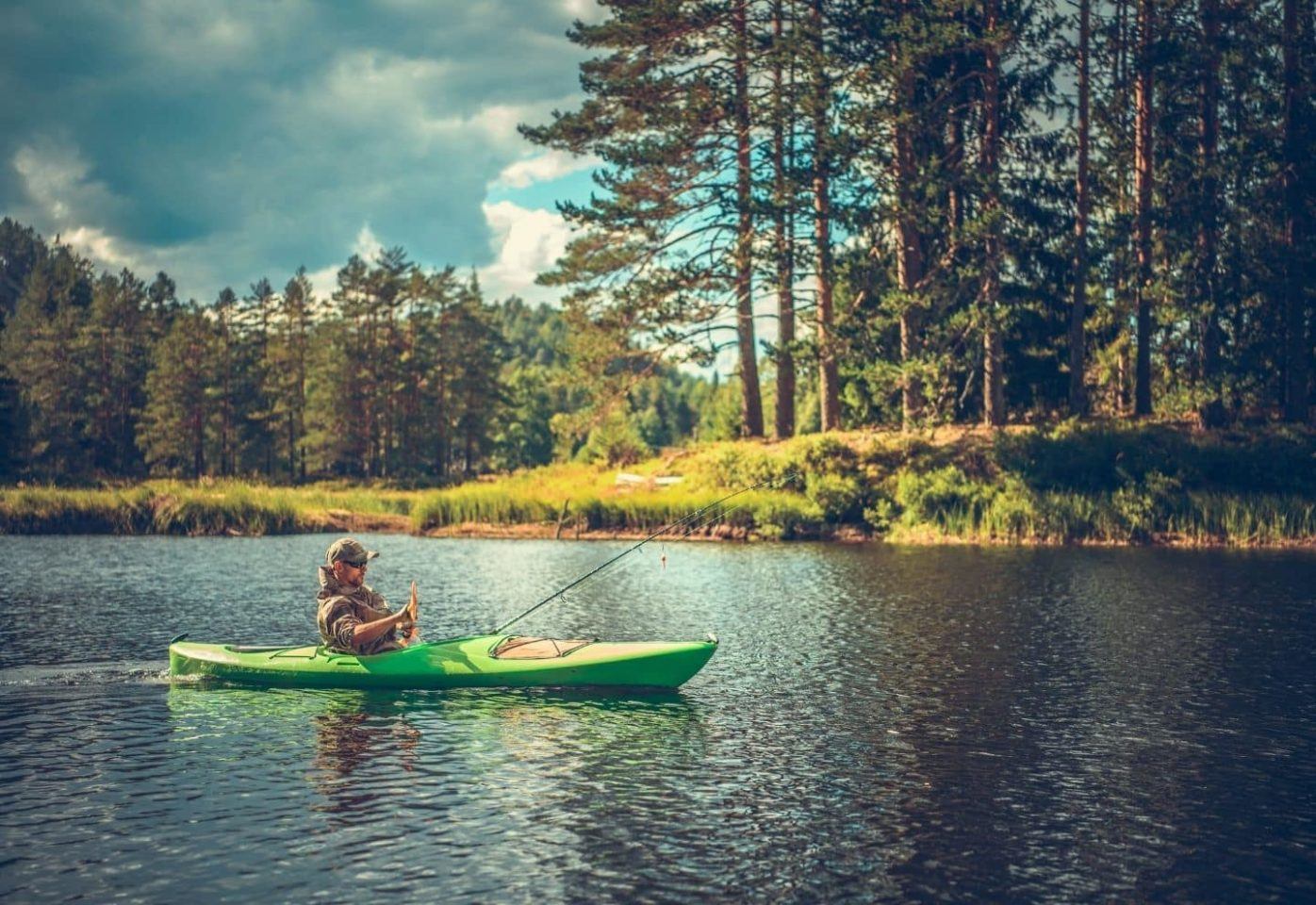 Man Fishing from a green kayak