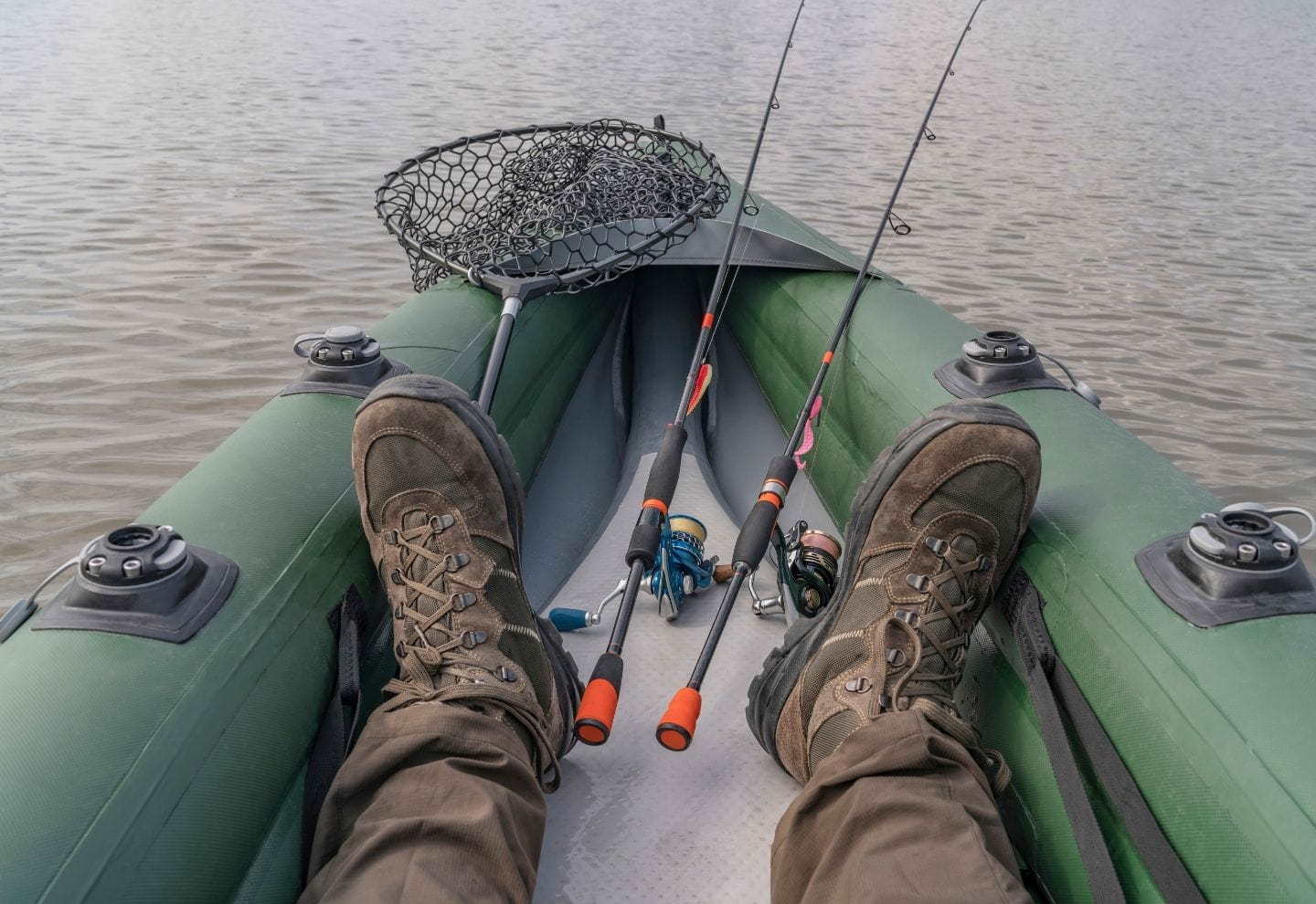 Feet of fisherman on inflatable boat