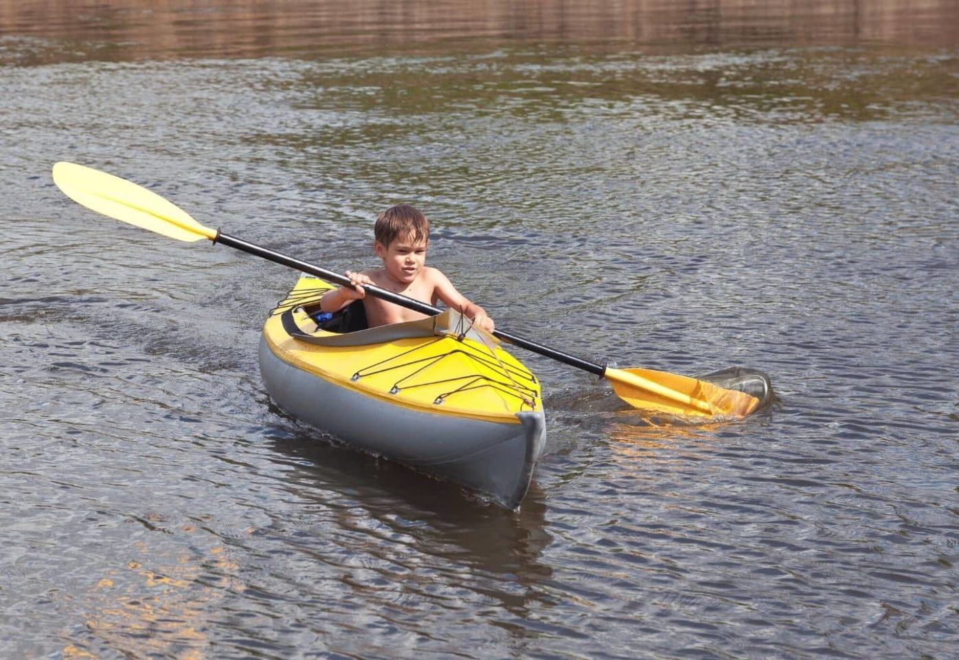 The little boy on a yellow kayak