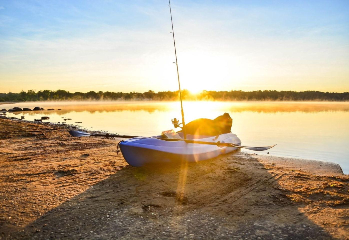 Fishing kayak on a shore during sunrise