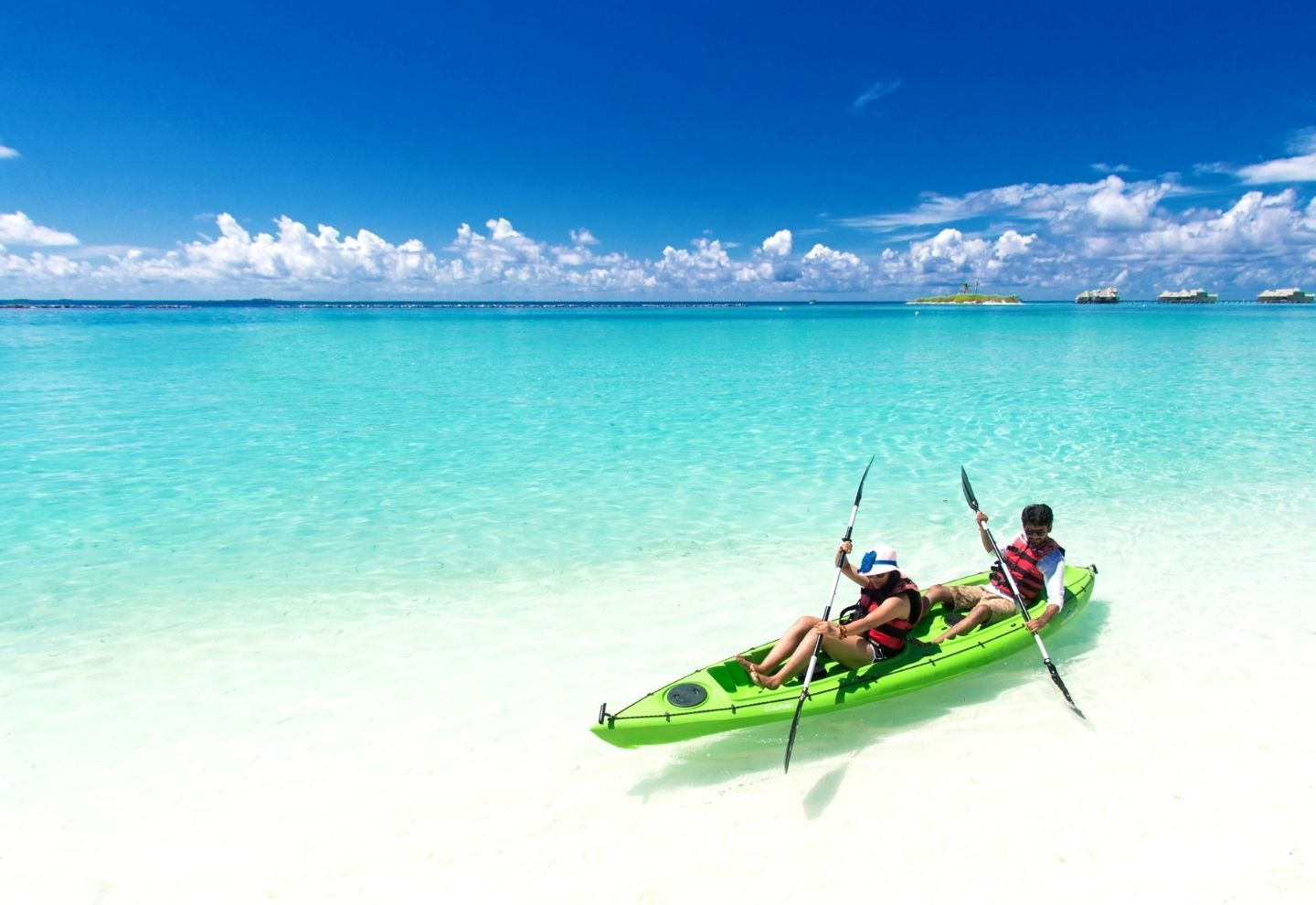2 person kayaking on a beach