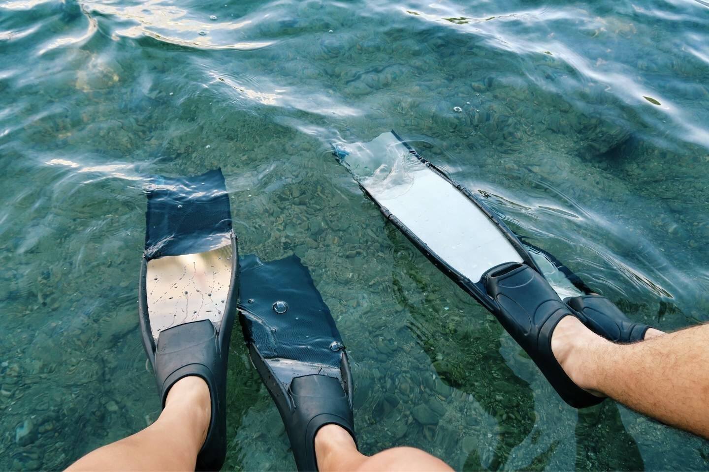 Freedivers in freediving fins on freediving lake