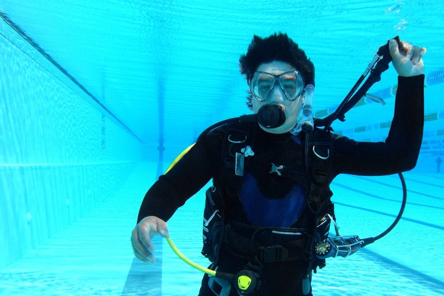 Scuba diver in clean swimming pool during scuba diving lesson