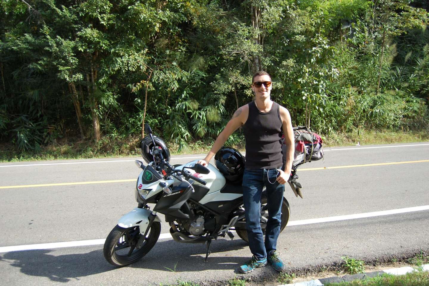 A man with motorbike on the road