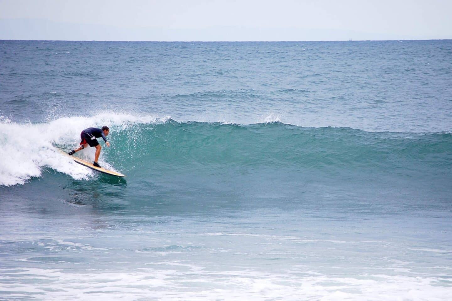 a man surfing in medewi