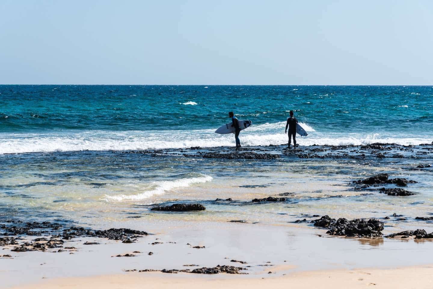 Two surfers on the beach in Corralejo
