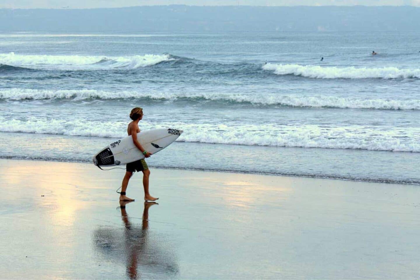 surfer walking around canggu