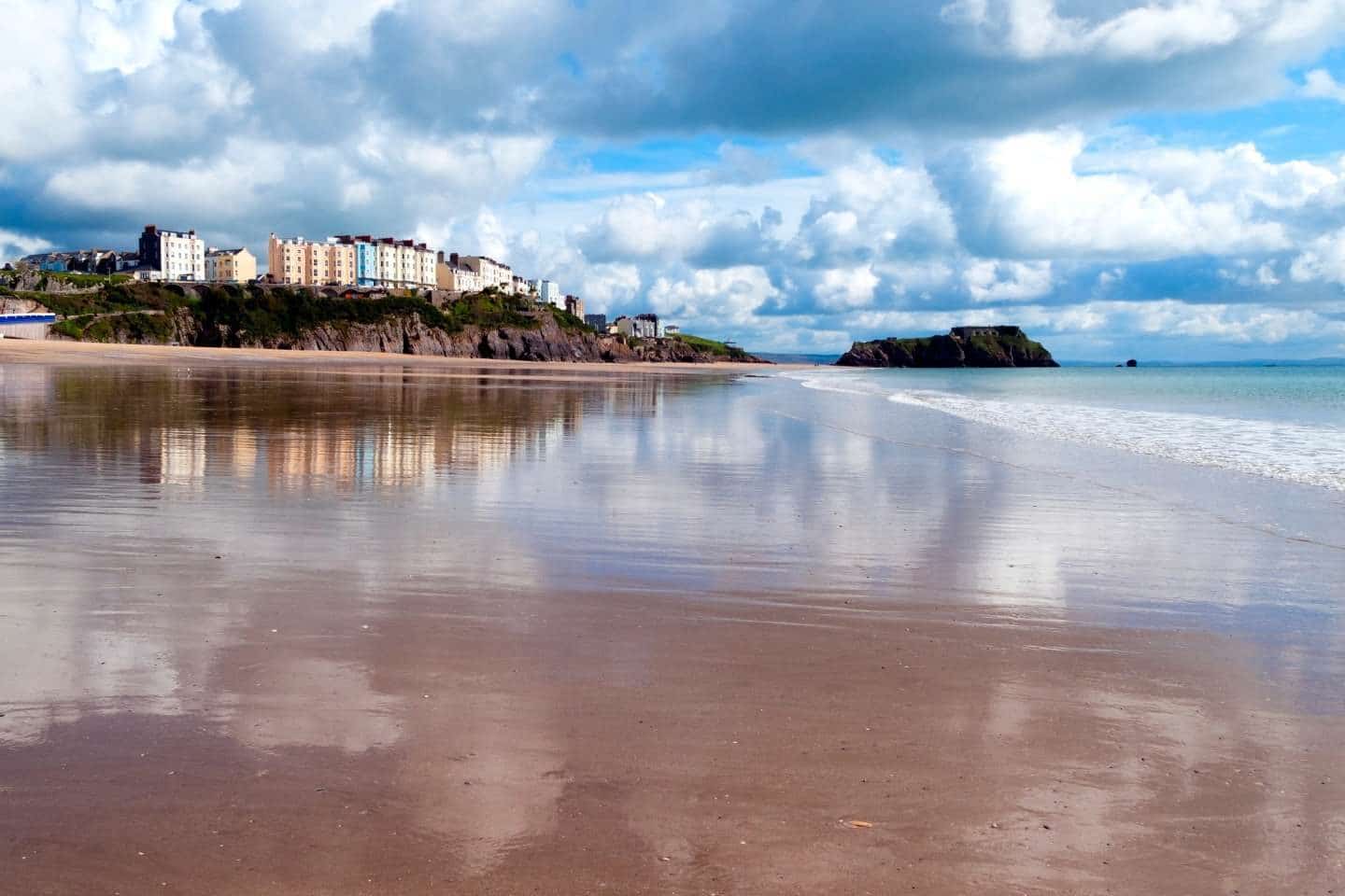 reflected in wet sand in south beach tenby