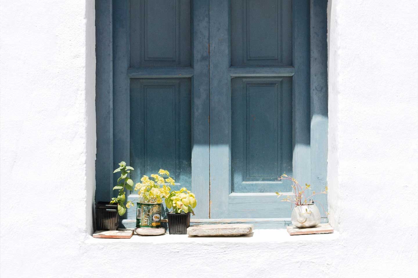 blue wooden shutters on a home in frigiliana spain