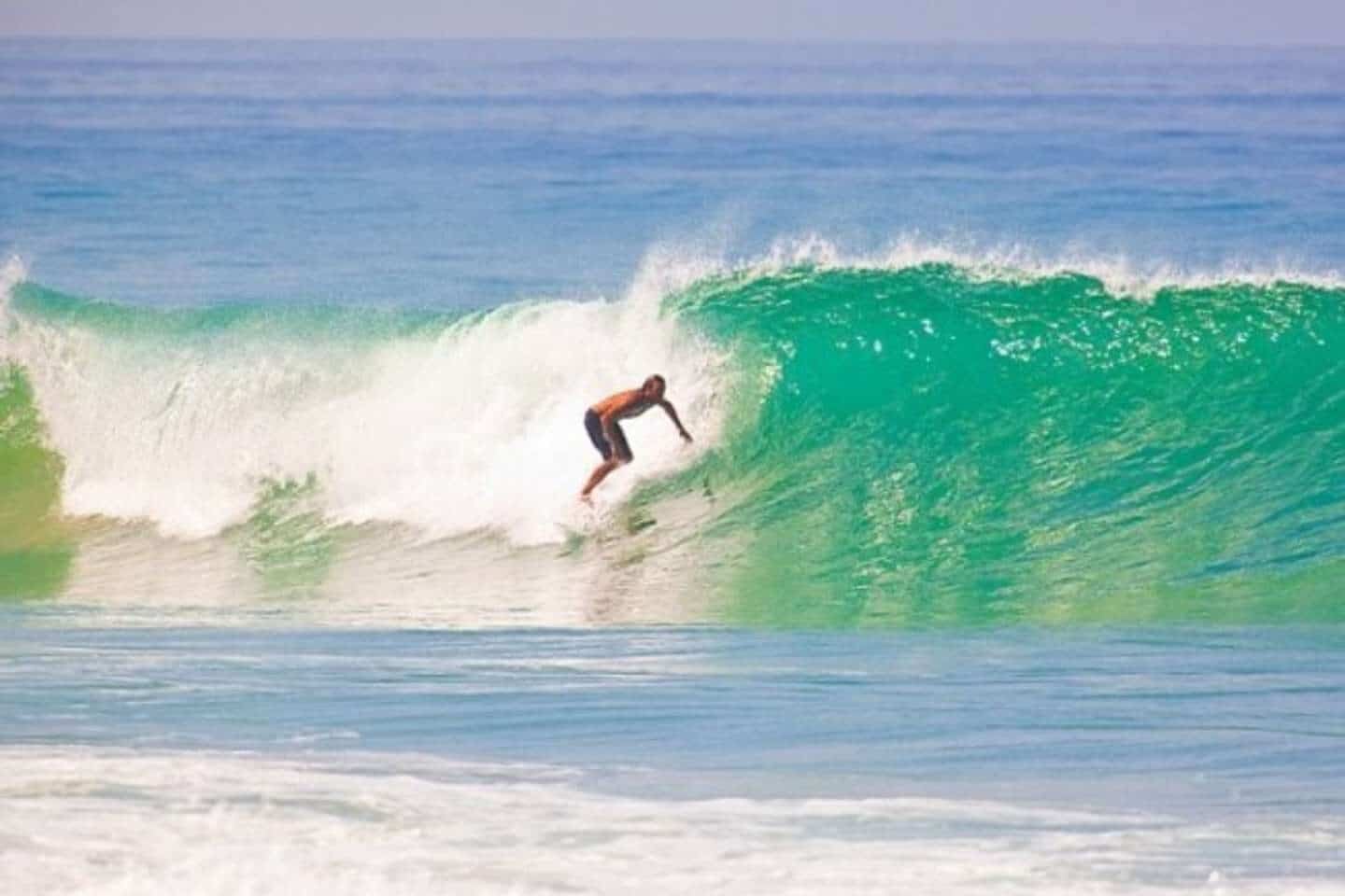 A man surfing the high waves at a Sri Lanka surf camp