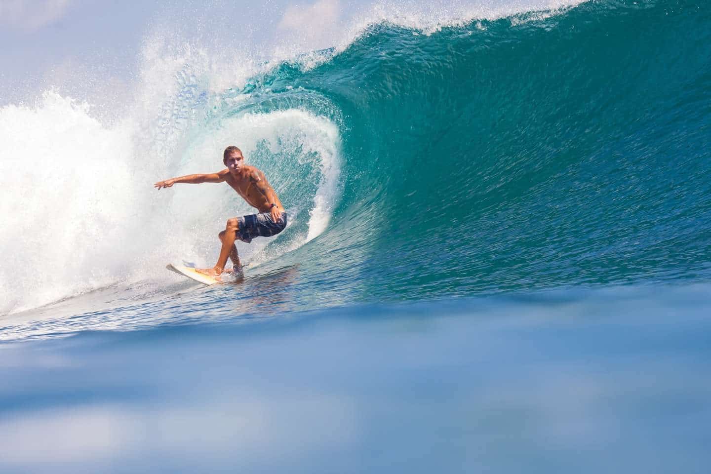A surfer riding the waves in Lombok, Indonesia