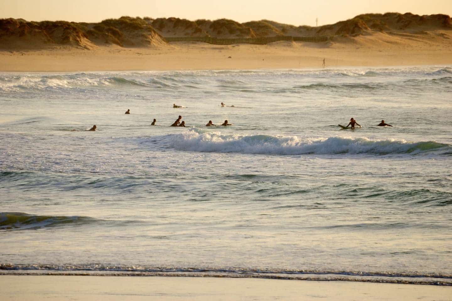 A group of people surfing in Peniche Centro Region