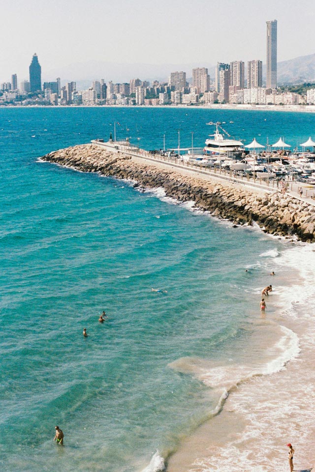A Spanish beach with city views in the distance