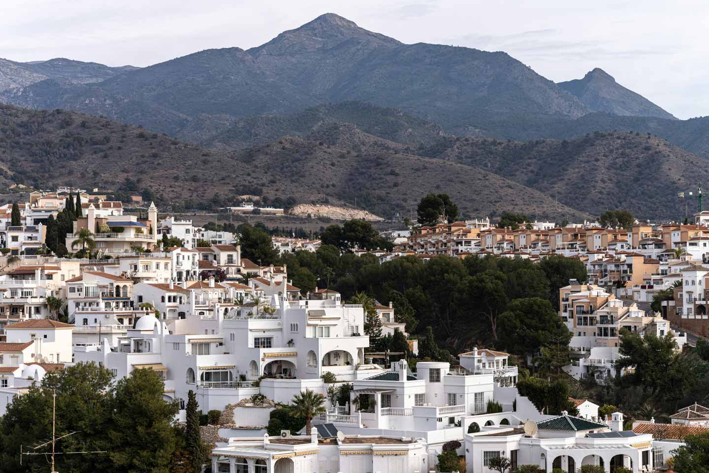 Whitewashed buildings and mountain views in Nerja, Spain